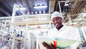A food machinery technician carrying out a standard maintenance procedure.