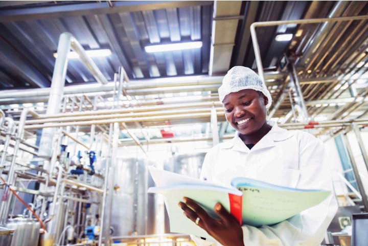 A food machinery technician carrying out a standard maintenance procedure.