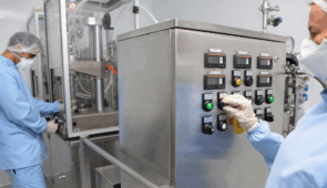 Two food machinery technicians setting up the automation on the food processing machine.