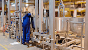 A technician regulating industrial cooking systems in the a warehouse