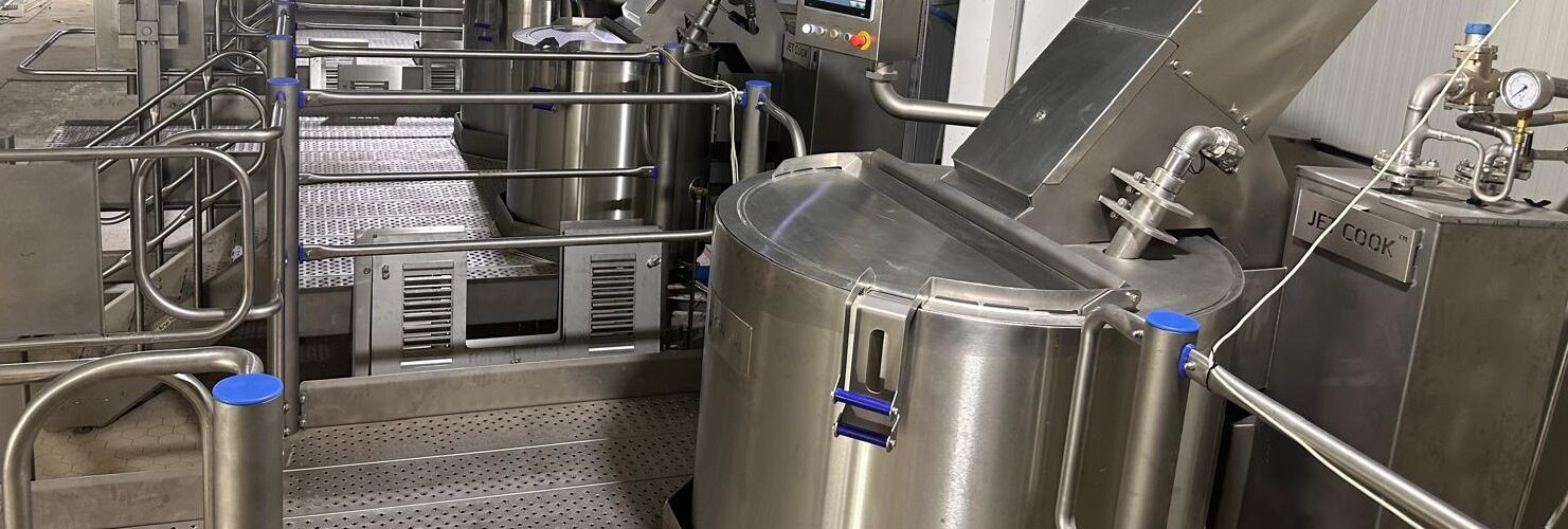 A ready meal food production process equipment being used at a food factory.