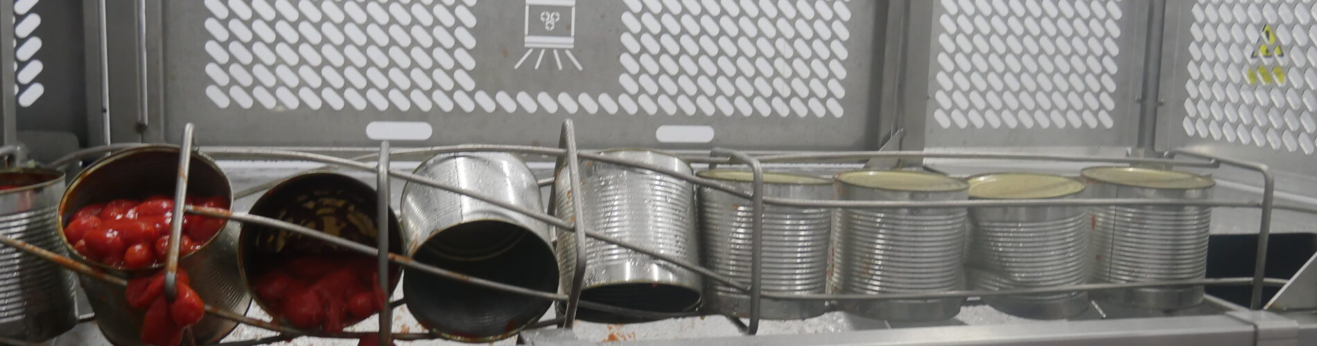 A line of industrial can opener for big cans​ being used for a food processer.