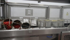 A line of industrial can opener for big cans​ being used for a food processer.