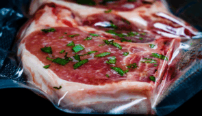 Industrial sous vide equipment used to vaccum meat in large food production system.