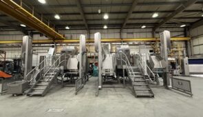 Multiple industrial cooking units in a manufacturing plant, representing industrial food cooking equipment in batch production environments.
