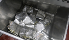 An industrial can crusher that has been used to crush food cans in a food factory.