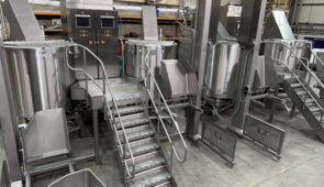 Large stainless steel industrial electric kettle used in commercial food processing and high-capacity industrial cooking operations.