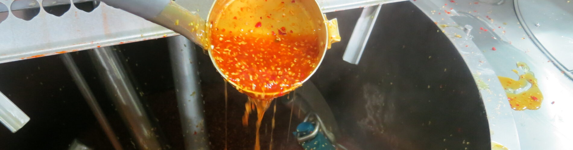 An industrial steam jacketed kettle processes a sauce to support consistent large-scale food production.