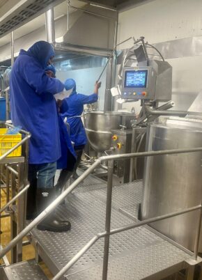 Food Manufacturing Training in a production facility with operators working on industrial food processing equipment.